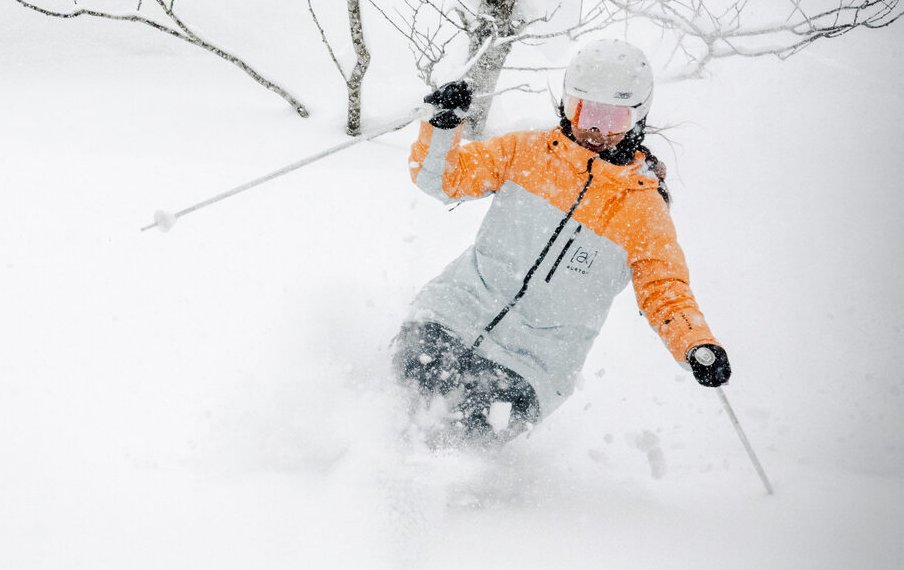 Skier slashing deep powder